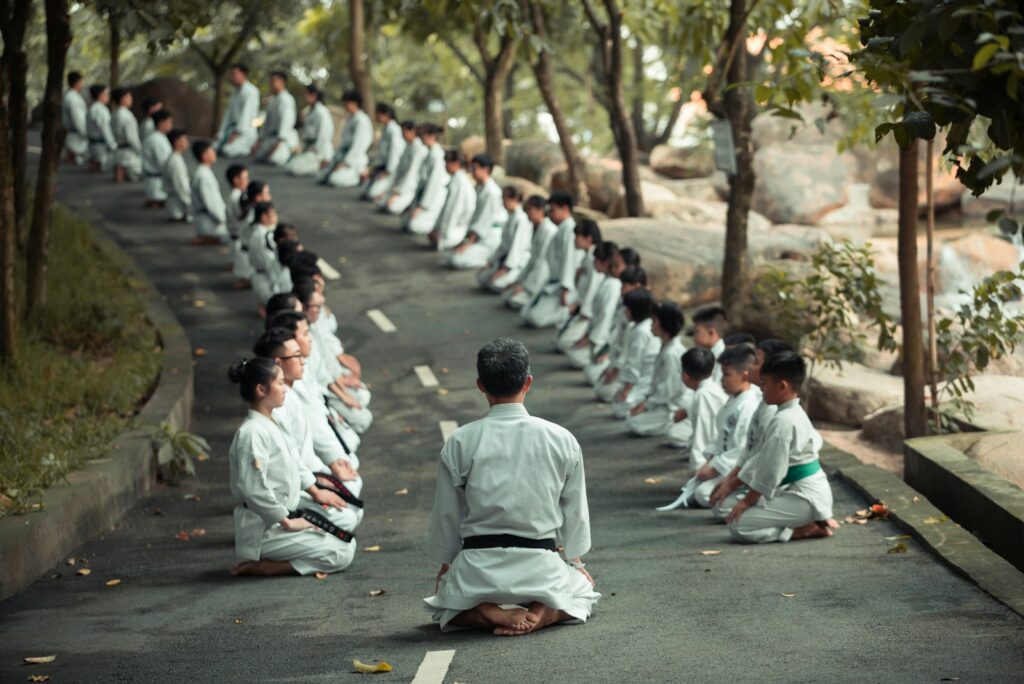 people in white uniform walking on road during daytime
