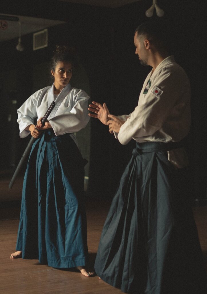 fhdl9yuujt0 - Customer Focus: Leadership Martial Arts A man and a woman standing in a dark room