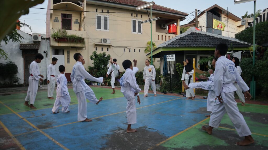 A group of people practicing karate on a court