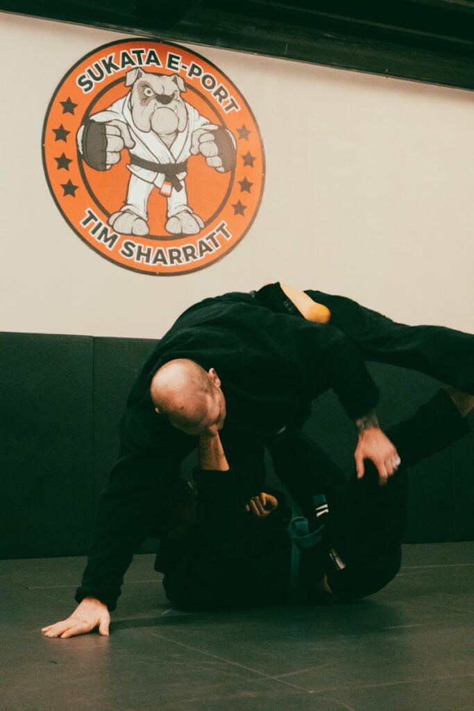 a man in black shirt doing a trick on a black mat